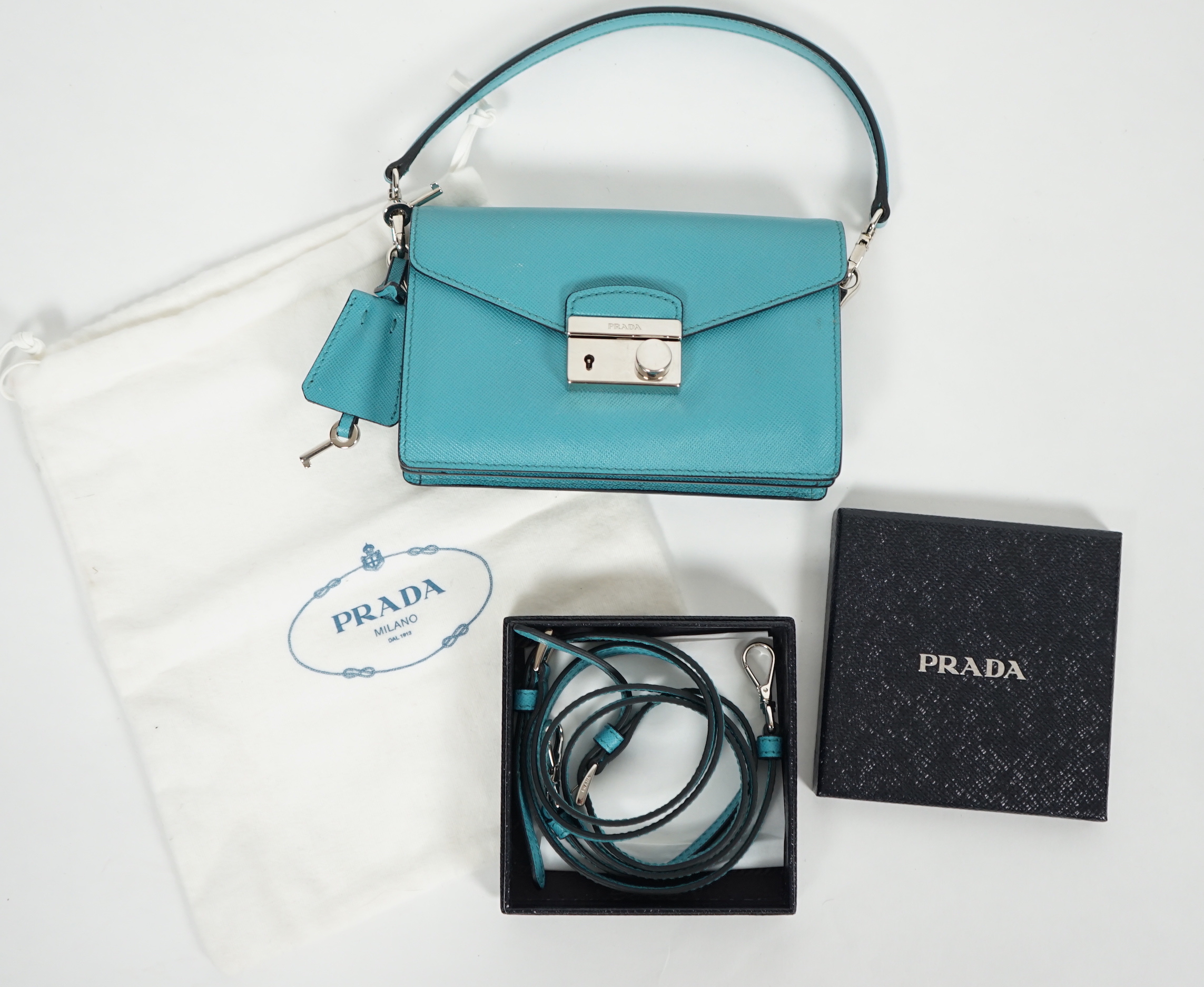 A Prada Saffiano Lux Mini Sound bag in Turchese, width 16cm, height 10cm, depth 4cm, overall height to handle 20cm